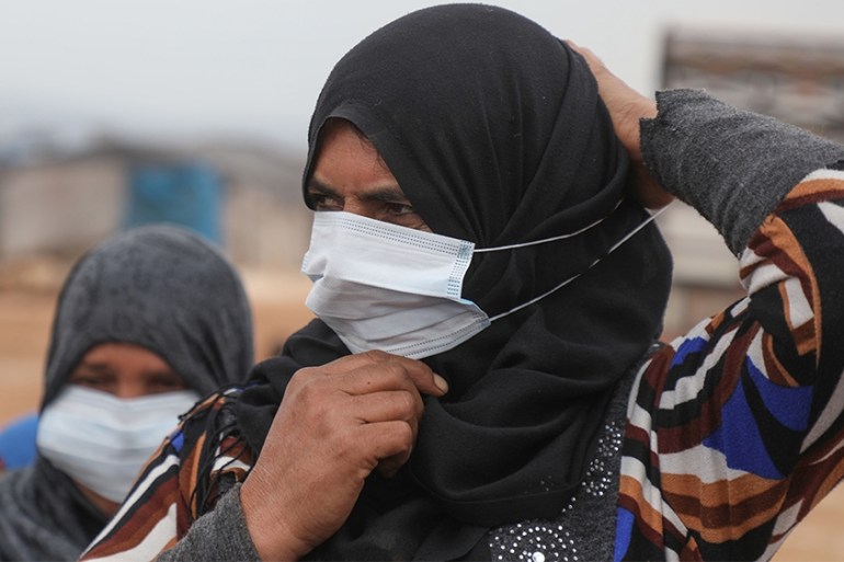 A Syrian woman wears a face mask during an awareness workshop on Coronavirus (COVID-19) held by Doctor Ali Ghazal at a camp for displaced people in Atme town in Syria''s northwestern Idlib province, ne