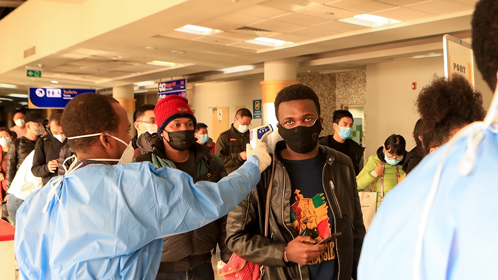 epa08291220 (FILE) - Kenyan health workers screening passengers wearing face masks after they arrived from China, at Jomo Kenyatta International Airport in Nairobi, Kenya, 29 January 2020 (reissued 13