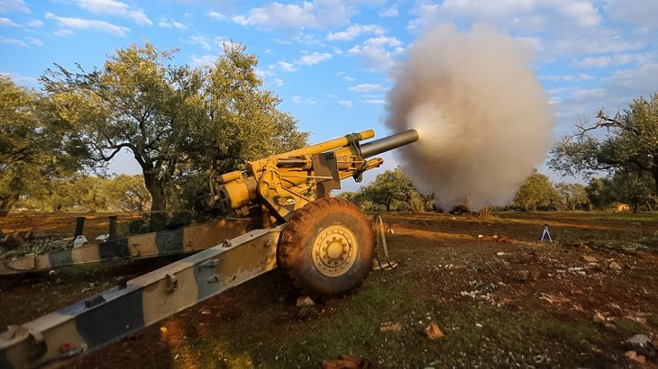 Turkish backed Syrian fighters fire a howitzer near the village of Neirab, in Idlib province, Syria, Monday, Feb. 24, 2020. (AP Photo/Ghaith Alsayed)