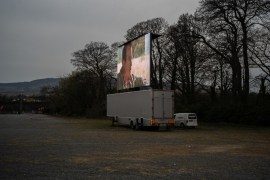 At the edge of an expansive parking lot serving Leopardstown Racecourse, a horse-racing venue in south Dublin, a 50 m square screen stands high ahead of another drive-in theatre session. Dublin, Irela