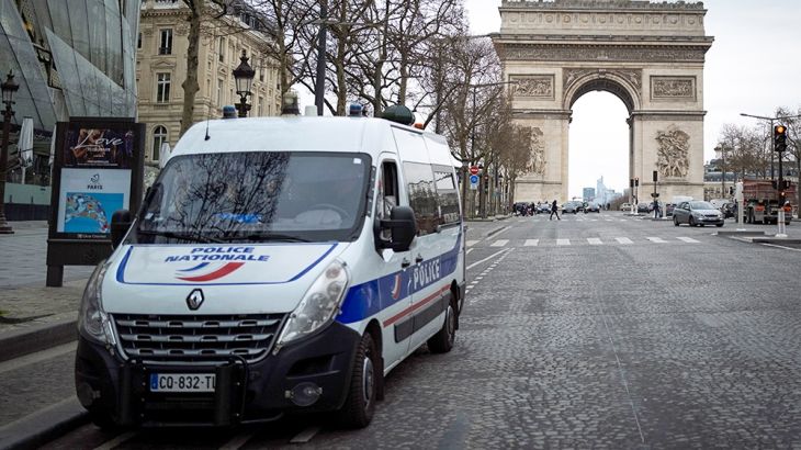A picture shows a police vehicle parked on the empty Champs-Elysees Avenue in Paris, as the Arc de Triomphe is seen in the background, on March 16, 2020, as all non-essential public places including