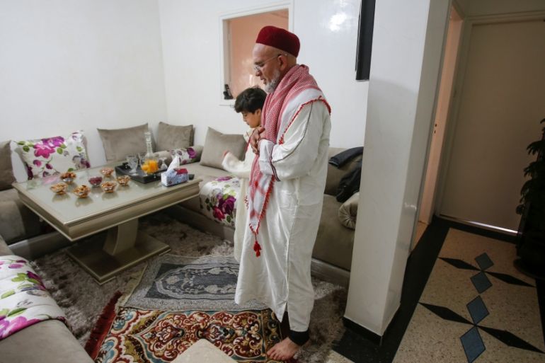 Ahmed, 57 and his son, 10 perform Friday prayers in their home as mosques are closed due to concerns about the spread of coronavirus disease in Casablanca