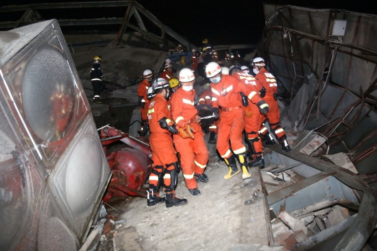 Rescue workers move casualty on the site where a hot