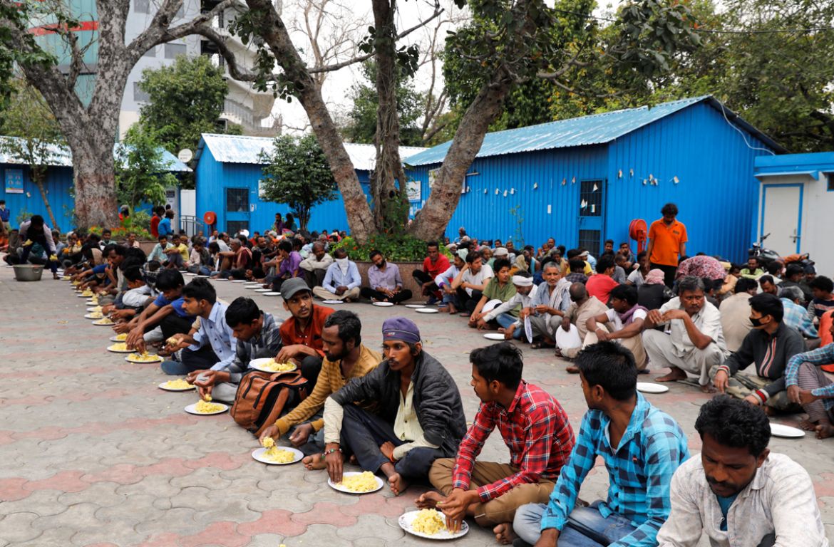 Daily wage workers and homeless people eat food inside a government-run night shelter during a 21-day nationwide lockdown to limit the spreading of coronavirus disease (COVID-19), in the old quarters