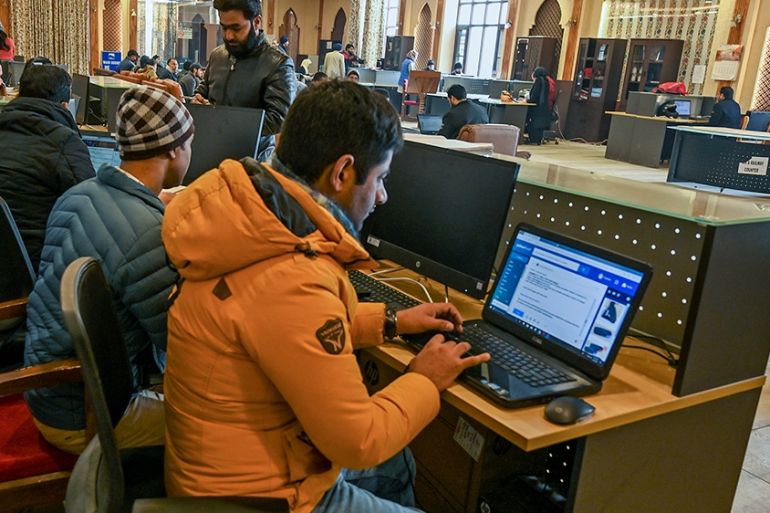 In this photo taken on December 3, 2019, Kashmiri students use the internet at a Tourist Reception Centre (TRC) in Srinagar, as internet facilities have been suspended across the region as part of a p