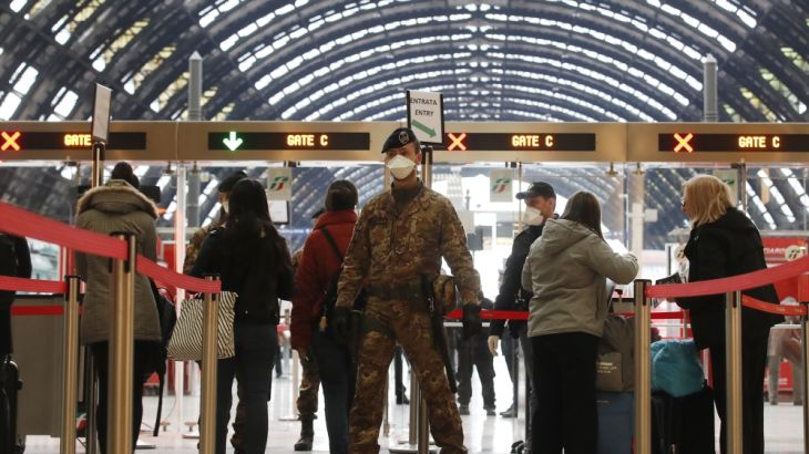 Police officers and soldiers check passengers leaving from Milan main train station, Italy, Monday, March 9, 2020. Italy took a page from China''s playbook Sunday, attempting to lock down 16 million pe