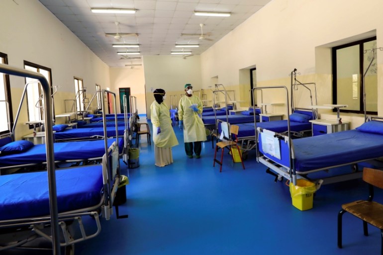 A Somali doctor and a nurse wear protective face masks as they prepare a ward for coronavirus disease (COVID-19) patients, at the Martini Hospital in Mogadishu