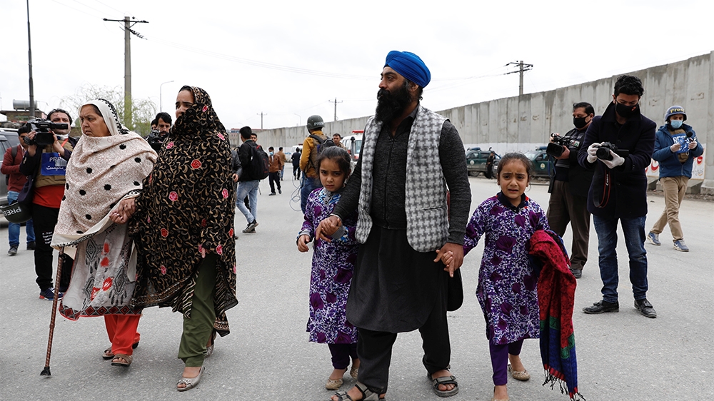 An Afghan Sikh family arrive to see their relatives near the site of an attack in Kabul, Afghanistan March 25, 2020.REUTERS/Mohammad Ismail