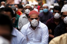 Muslims wear protective face masks following the coronavirus outbreak, as they pray on street during Friday prayers in local souq, in Manama