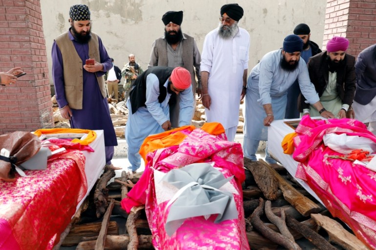 Afghan Sikh men prepare coffins before light the funeral pyre for the victims who were killed during yesterday''s attack at Sikh religious complex during a funeral in Kabul, Afghanistan