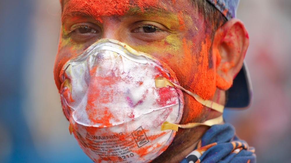A man wearing protective mask attends Holi celebrations amid coronavirus precautions India