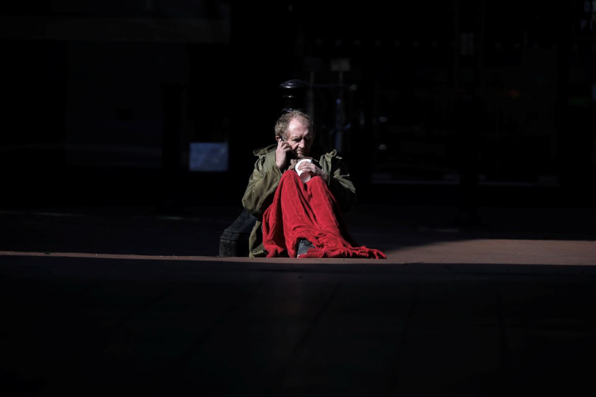 Ian Moore, 59, who has been homeless since 2019 sits outside a tube station, as the number of coronavirus disease (COVID-19) cases grow around the world, in London, Britain, March 22, 2020. REUTERS/K