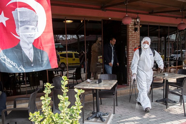 epa08282677 Turkish municipality workers carry out disinfection against the novel coronavirus Covid-19 at the Karaagac Village, where migrants and refugees came for shopping from the Turkish-Greek bor
