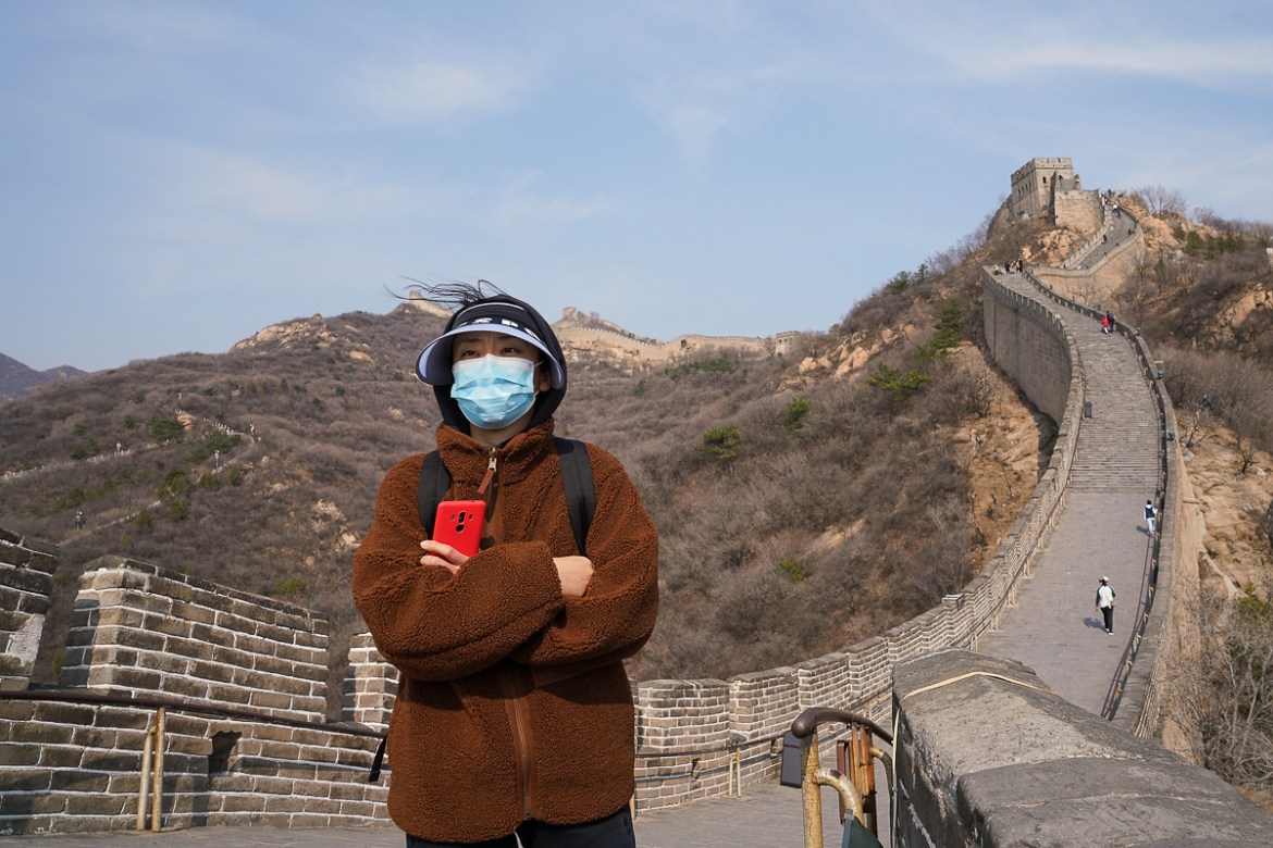 BEIJING, CHINA - MARCH 24: A Chinese tourist wears a protective mask as she visit the almost empty Badaling Great Wall on March 24, 2020 in Beijing, China. Affected by the new coronavirus covid-19, t