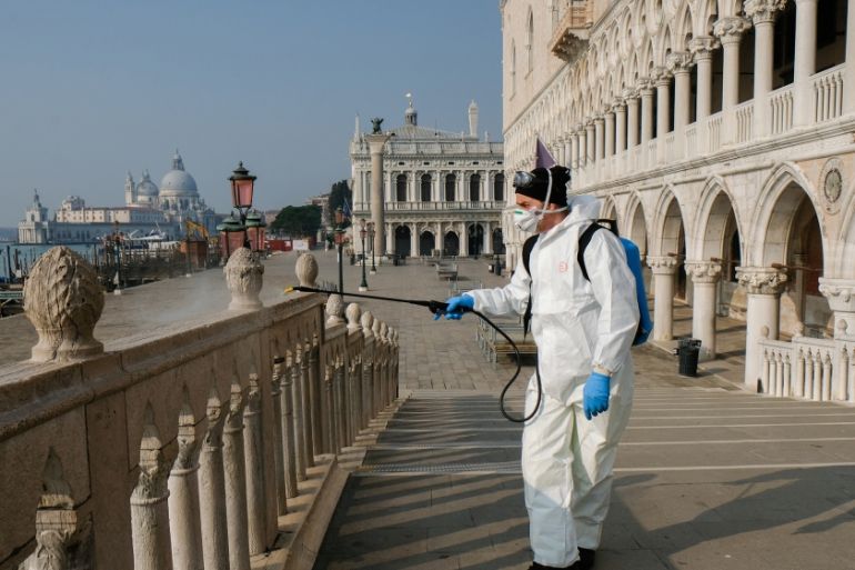 A worker sanitises Ponte della Paglia bridge on St. Mark''s square as a measure to fight against the coronavirus contagion in Venice, Italy, March 12, 2020. REUTERS/MANUEL SILVESTRI