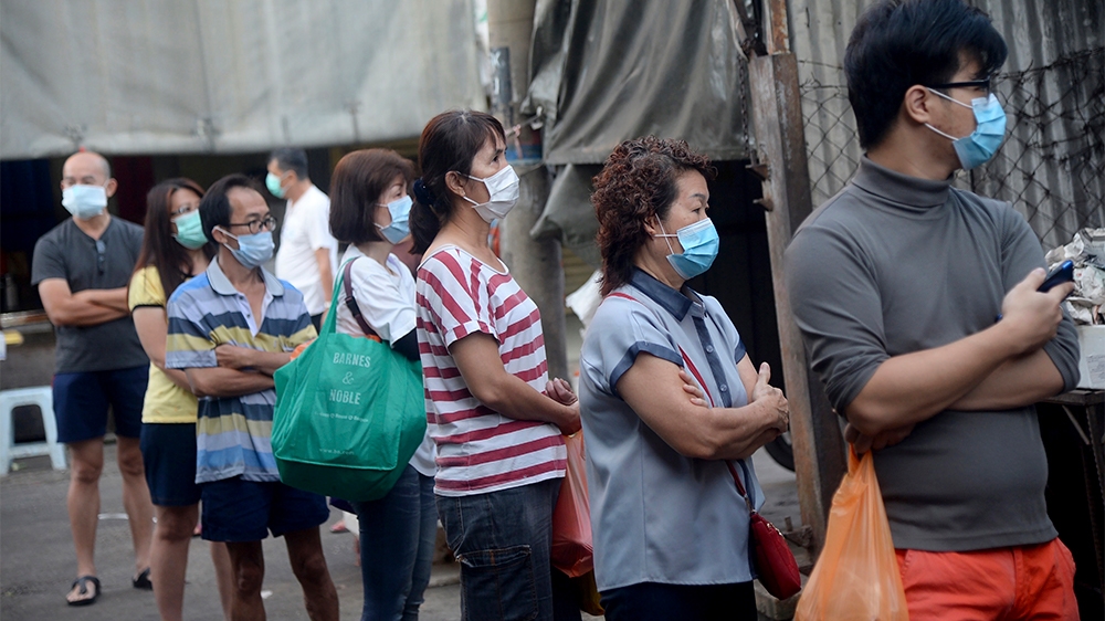 Residents wearing face mask line up outside a wet market during the movement control order due to the outbreak of the coronavirus disease (COVID-19) outside of Kuala Lumpur, Malaysia, on Wednesday, Ma