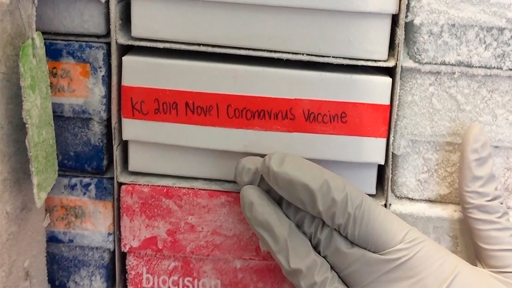 In this undated frame from video provided by the National Institute of Allergy and Infectious Diseases (NIAID), a scientist returns a novel coronavirus vaccine sample to a freezer in Bethesda, Md. The