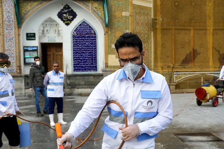 Workers disinfect the shrine of the Shiite Saint Imam Abdulazim to help prevent the spread of the new coronavirus in Shahr-e-Ray, south of Tehran, Iran, Saturday, March, 7, 2020. (AP Photo/Ebrahim Nor