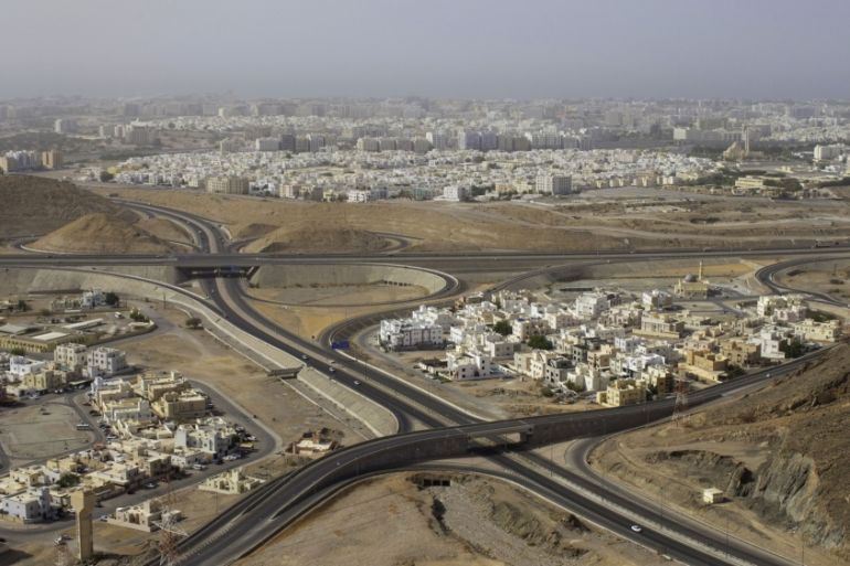 Oman:Highways intersect residential housing quarters in the Bawshar district