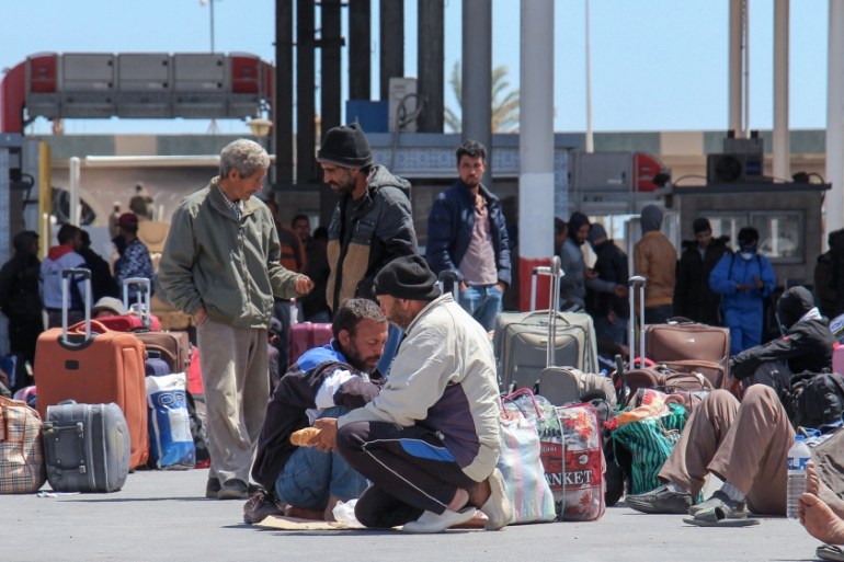 Tunisian workers stranded in Libya wait at the Ras Jedir border post to return to their country on April 21, 2020. Hundreds of Tunisians stranded for weeks in war-racked Libya due to the coronavirus h