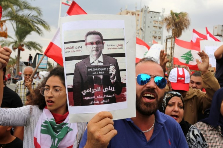 Demonstrators carry Lebanese flag
