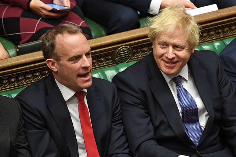 A handout photograph released by the UK Parliament shows Britain''s Prime Minister Boris Johnson (C) smiling beside (L-R) Britain''s Leader of the House of Commons J