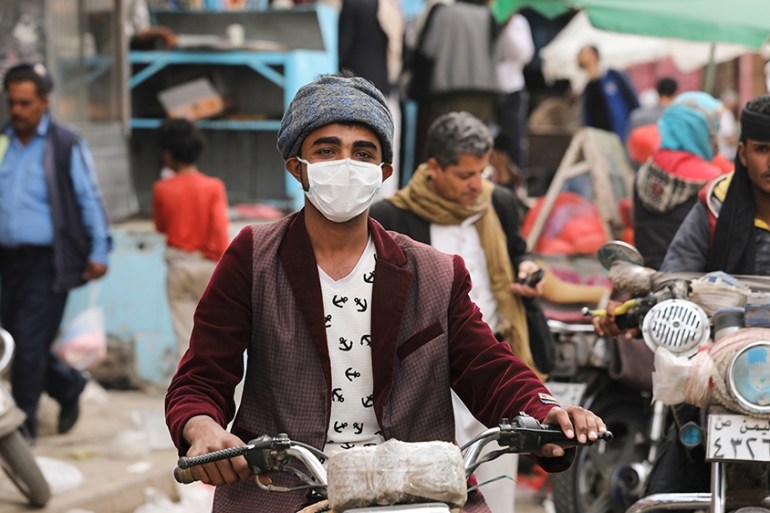 A man wears a protective face mask as he rides a motorcycle amid fears of the spread of the coronavirus disease (COVID-19) in Sanaa, Yemen March 16, 2020. Picture taken March 16, 2020. REUTERS/Khaled