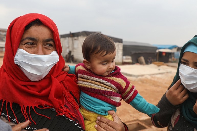 Syrian women wear face masks during an awareness workshop on Coronavirus (COVID-19) held by Doctor Ali Ghazal at a camp for displaced people in Atme town in Syria''s northwestern Idlib province, near