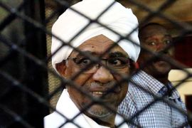 Sudan''s former president Omar Hassan al-Bashir smiles as he is seen inside a cage at the courthouse where he is facing corruption charges, in Khartoum, Sudan August 31, 2019. REUTERS/Mohamed Nureldin