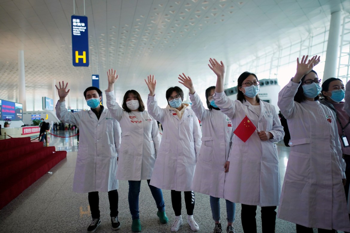 Medical workers wave goodbye to a medical team from Jilin at the Wuhan Tianhe International Airport after travel restrictions to leave Wuhan, the capital of Hubei province and China''s epicentre of the