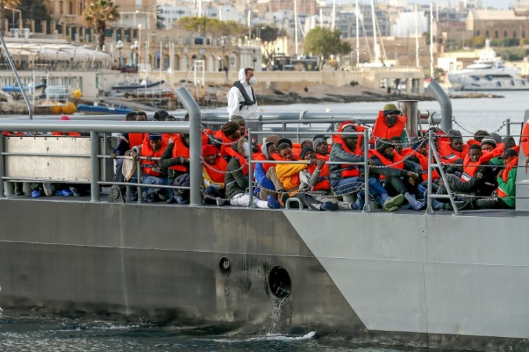 Migrants who were stranded on the German NGO Sea-Eye migrant rescue ship Alan Kurdi are seen before disembarking from an Armed Forces of Malta patrol boat at its base in Marsamxett Harbour, Valletta,