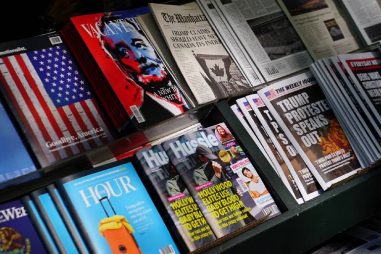 A news stand with newspapers and magazines.