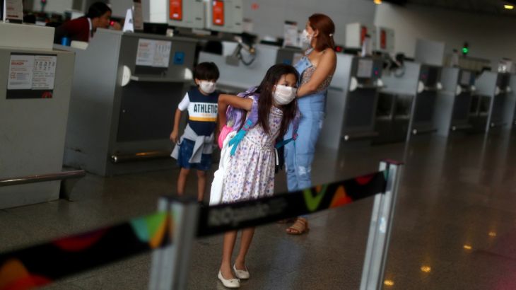 A woman and children are seen at the Galeao International Airport after flights were cancelled, during the coronavirus disease (COVID-19) outbreak in Rio de Janeiro, Brazil April 1, 2020. REUTERS/Pila