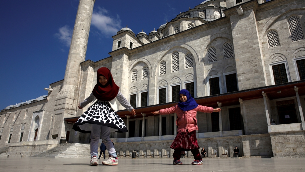 Children play in front of the locked Fatih Mosque as Turkey suspended mass prayers in mosques nationwide until the risk of coronavirus disease (COVID-19) passes in Istanbul