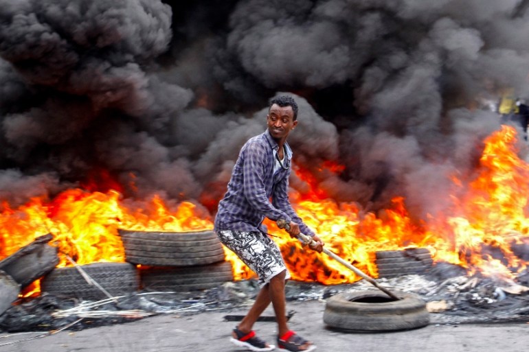 A Somali man protests against the killing Friday night of at least one civilian during the overnight curfew, which is intended to curb the spread of the new coronavirus