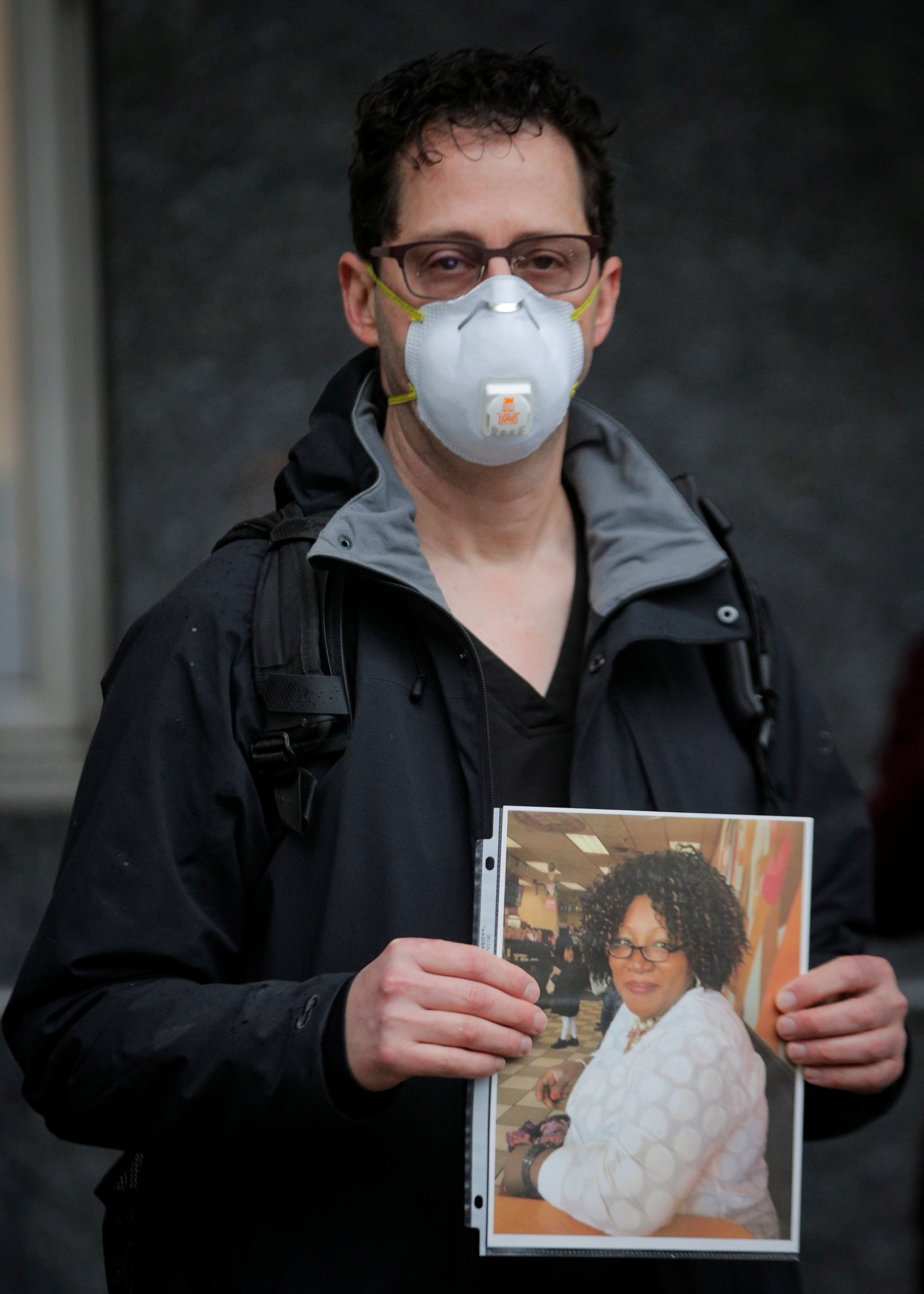 
Ted Levine, a healthcare worker at Mount Sinai Hospital, holds a photo of Feda Ocran, a nurse who died of coronavirus disease [Brendan McDermid/Reuters]
