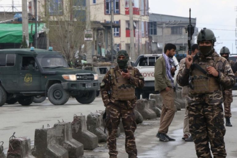 Afghan security personnel stand guard near the site of an attack to a Sikh temple in Kabul on March 25, 2020. The Islamic State group has claimed an attack on a Sikh-Hindu temple