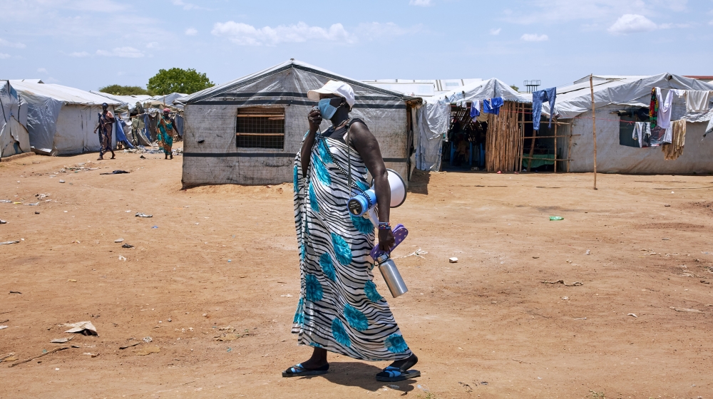 A Unicef social mobilizer uses a speaker as she carries out public health awareness to prevent the spread and detect the symptoms of the COVID-19 coronavirus by UNICEF at Mangateen IDP camp in Juba, S