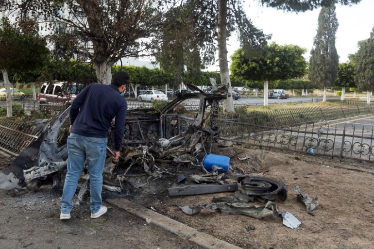 A man inspects the wreckage of a car outside the Khadra General Hospital which is dedicated to treating people infected with coronavirus (COVID-19) in the Libyan capital Tripoli on April 8, 2020, afte