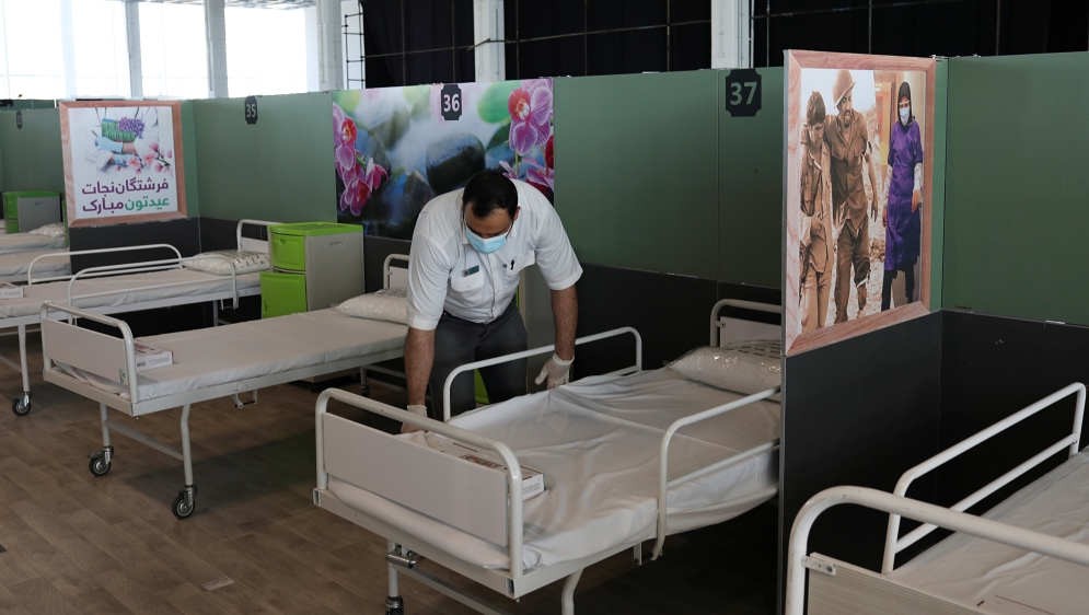 A medical aid worker sets up and installs a bed at a shopping mall, one of Iran's largest, which has been turned into a centre to receive patients suffering from the coronaviru (COVID-19), in Tehran