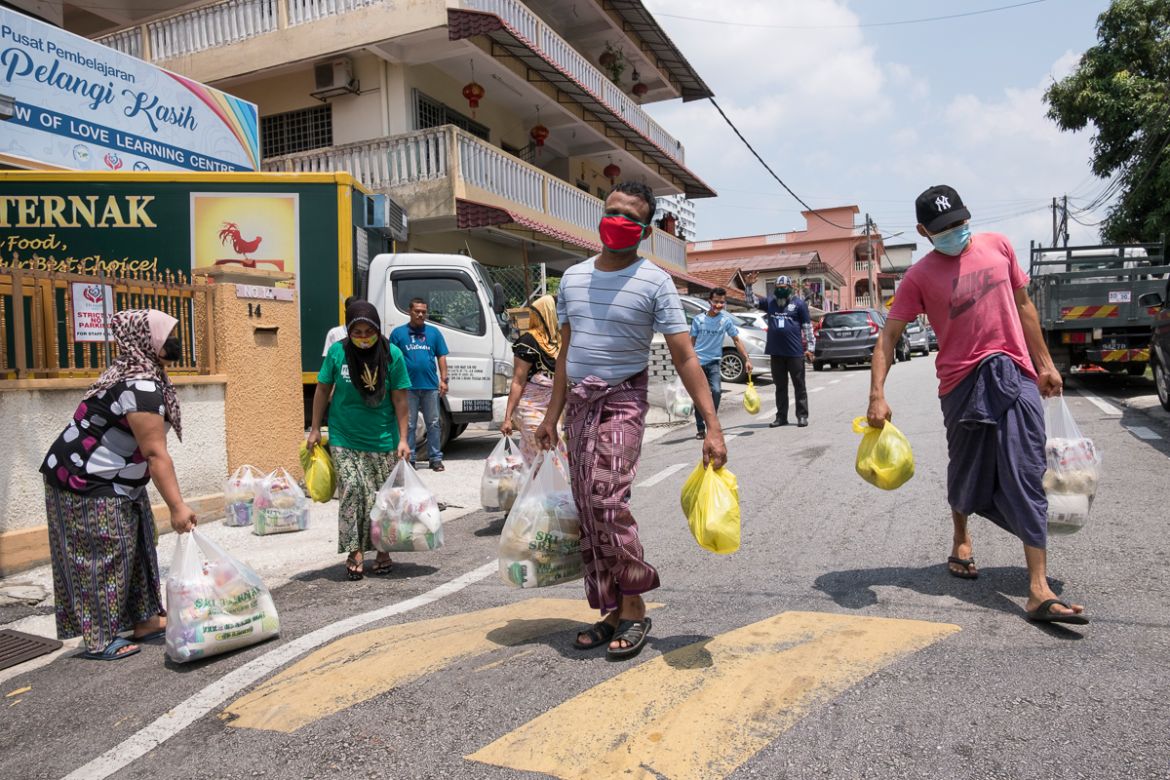 Refugees in the Selayang area, at the outskirts of Kuala Lumpur, receive dry and fresh food from “Rainbow of love”, a community centre established by the refugee community itself. “Officially we have