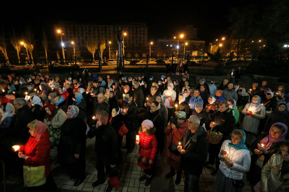 Believers attend the Orthodox Easter service outside the Holy Transfiguration Cathedral amid the coronavirus disease (COVID-19) outbreak in the rebel-controlled city of Donetsk, Ukraine April 18, 2020