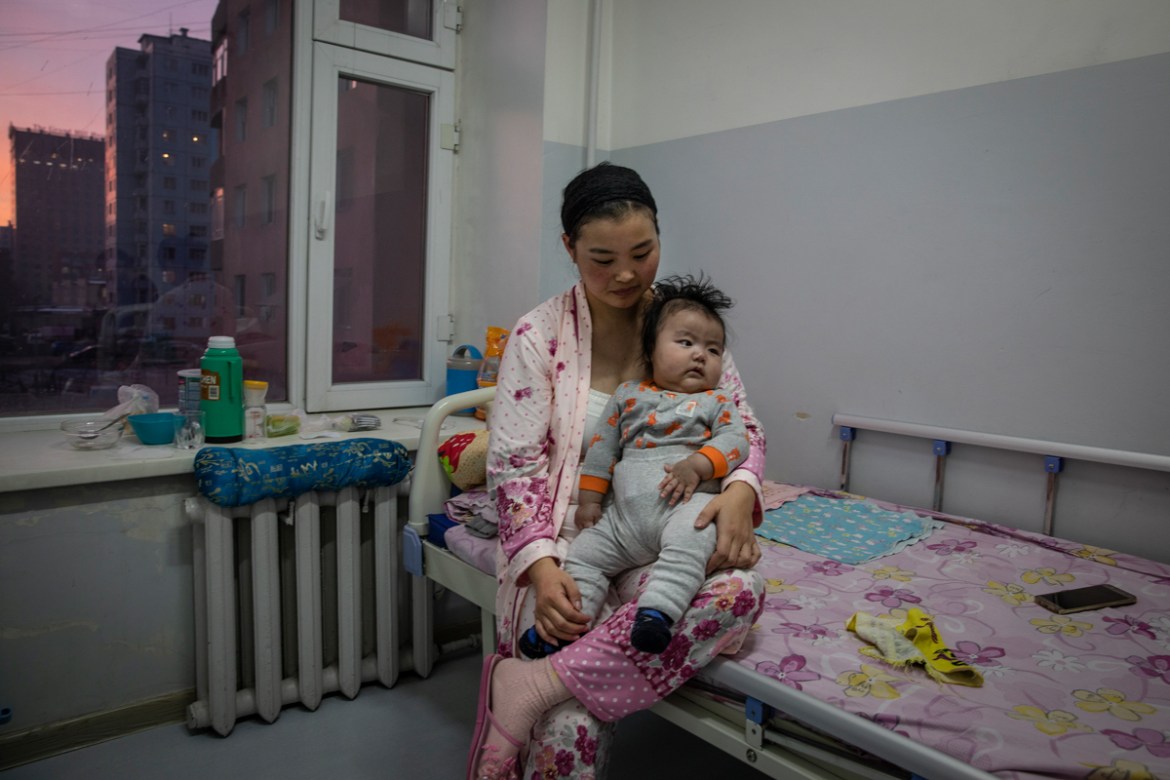 A mother holds her baby boy who has been suffering from pneumonia in a paediatric unit in one of the city hospitals in the capital Ulaanbaatar, January 15, 2019. An ever-increasing number of children