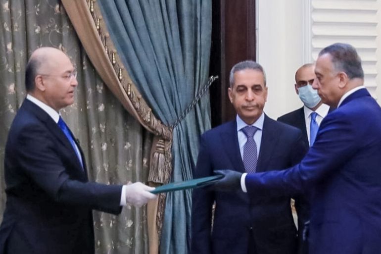 Iraq''s President Barham Salih instrcuts newly appointed Prime Minister Mustafa al-Kadhimi in Baghdad, Iraq April 9, 2020. The Presidency of the Republic of Iraq Office/Handout via REUTERS ATTENTION ED