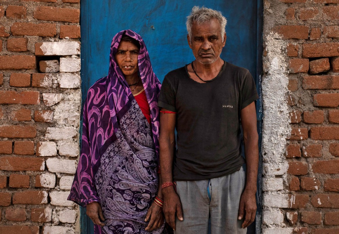 Kesra (L) and Takur Das, migrant workers and parents of Dayaram Kushwaha, a migrant worker who returned home from New Delhi, pose for a portrait during nationwide lockdown in India to slow the spread