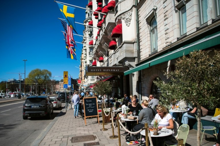 People have lunch outdoors at a restaurant in Stockholm