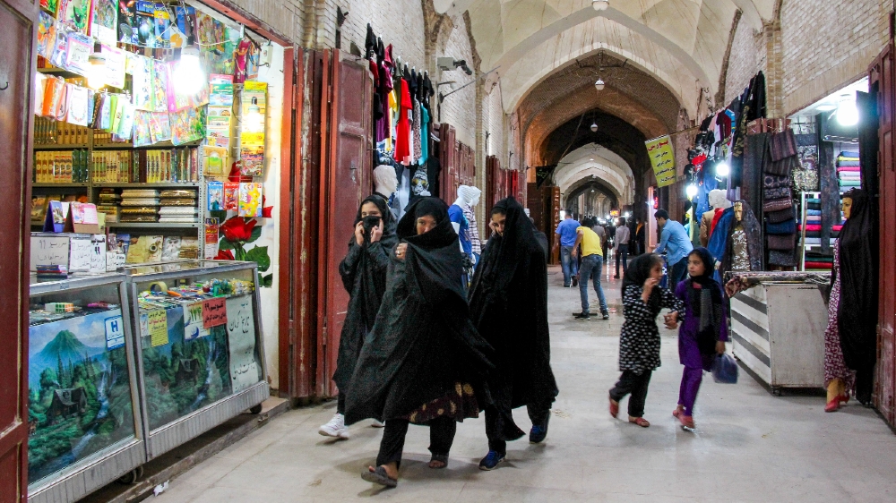 IRAN-HEALTH-VIRUS  Iranians, some wearing personal protective equipment, walk past shops in the southeastern city of Kerman on April 11, 2020, amid the coronavirus (COVID-19) pandemic. 