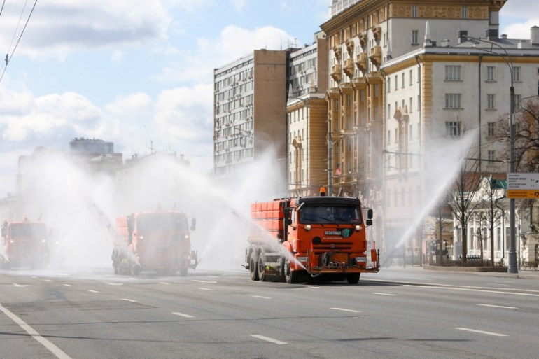 Vehicles drive near the U.S. embassy and spray disinfectant while sanitizing a road to prevent the spread of the coronavirus disease (COVID-19) in Moscow, Russia April 12, 2020. Andrey Nikerichev/Mosc