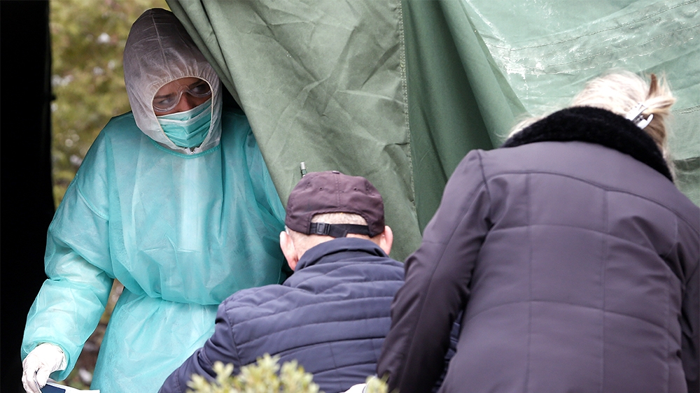 epa08321418 People wait for a corona test at a tent outside the State Hospital in Sarajevo, Bosnia and Herzegovina, 25 March 2020. Several European countries have closed borders, schools, public facil