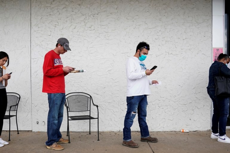 People who lost their jobs wait in line to file for unemployment following an outbreak of the coronavirus disease (COVID-19), at an Arkansas Workforce Center in Fayetteville, Arkansas, U.S. April 6, 2